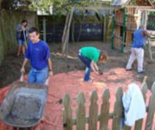 Members of Dr. Howard Mielke's research team improve the soil environment at a New Orleans daycare center by spreading clean soil (less than 5 ppm lead) over a geotextile layer. Credit: Howard Mielke